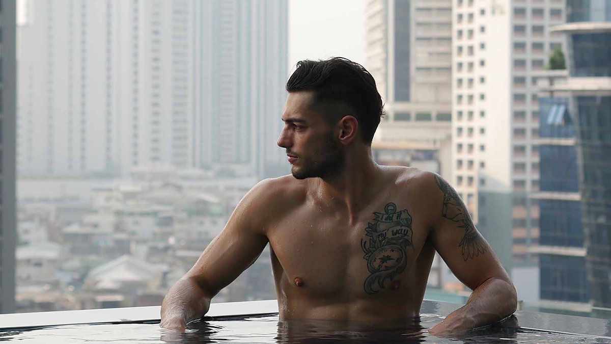 Erhan Güngör on a rooftop above the skyline